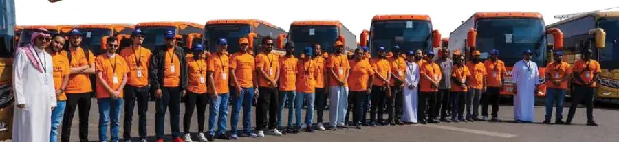 Northwest Bus team lineup in front of buses